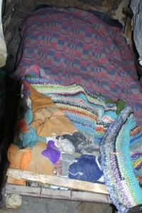 This is the bed I slept in with my 3 siblings.  We did not have a mattress.  We used torn clothing to fill the spaces between the wood.